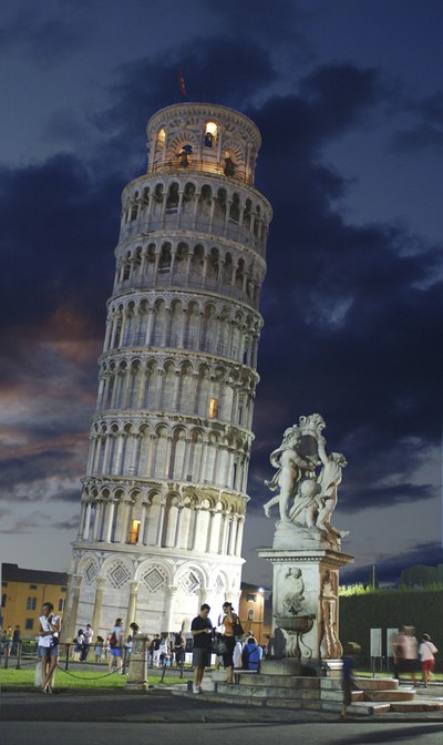 Leaning Tower of Pisa at dusk with statue